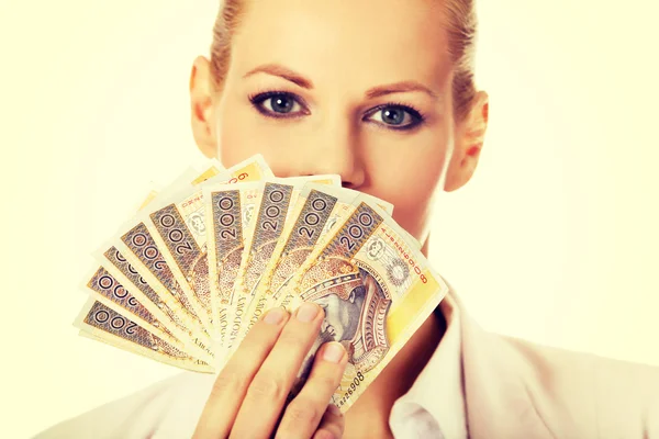 Business woman holding a clip of polish money