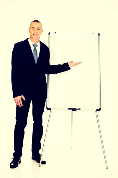 Male executive presenting on flip chart