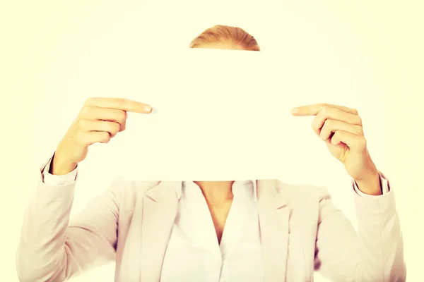Business woman covering face with blank paper sheet