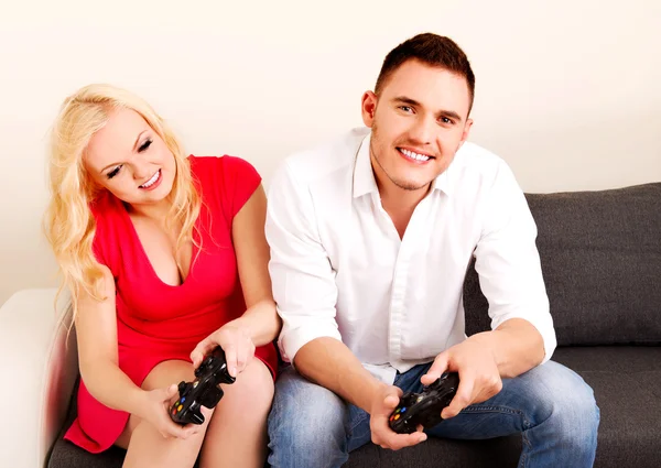 Happy young couple playing video games