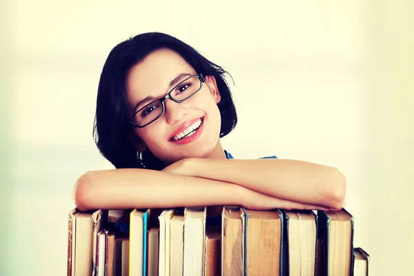 Happy smiling young student woman with books