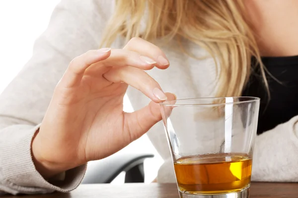 Yound woman in depression, drinking alcohol