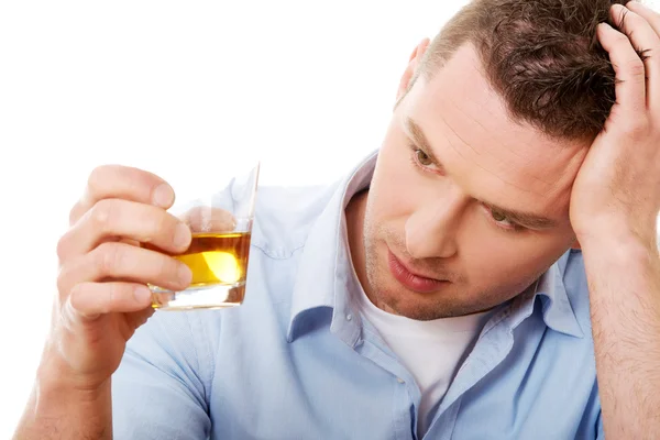Yound man in depression, drinking alcohol