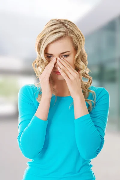 Woman with sinus pressure pain