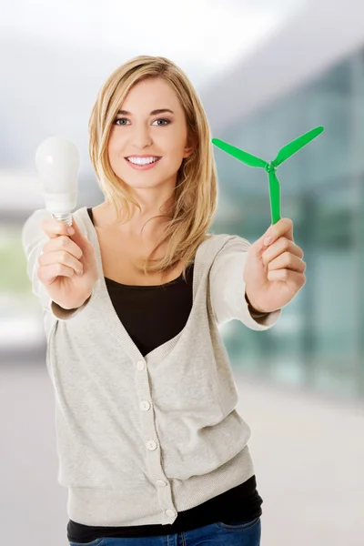 Woman with led light bulb and windmill