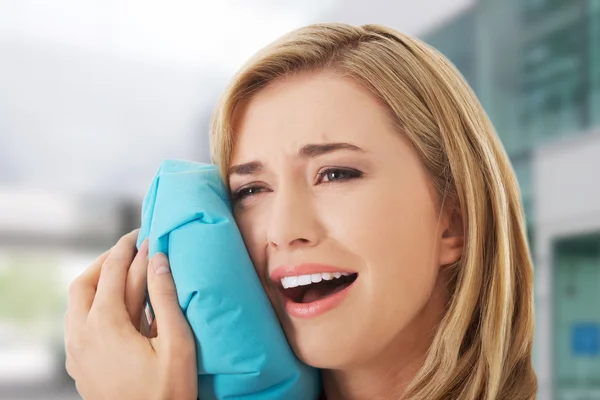 Woman having tooth ache