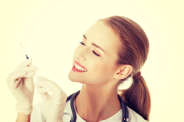 Beautiful young nurse or doctor with needle.