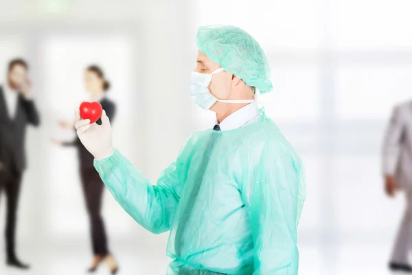 Surgeon doctor holding a heart.