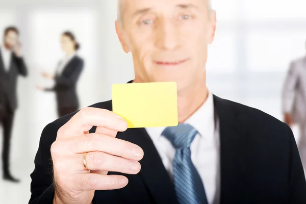 Businessman showing a blank card.