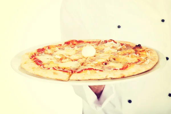 Hand of chef baker with italian pizza on plate