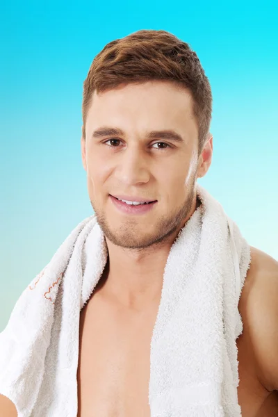 Young athletic man with a towel.