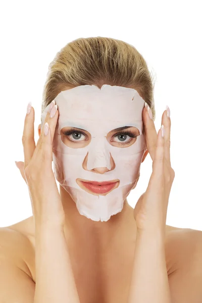 Young happy woman with facial mask.