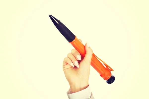Businesswomans hand pointing up with big pen.