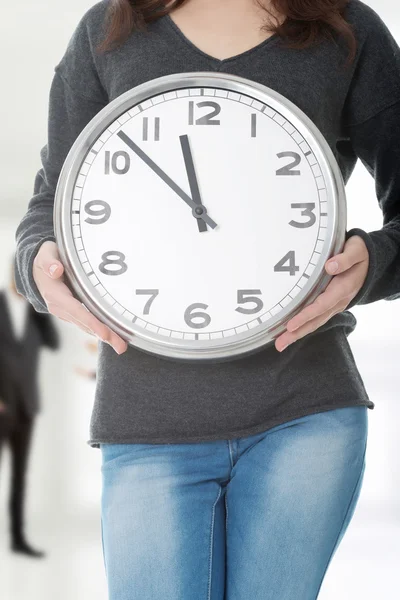 Young woman with clock