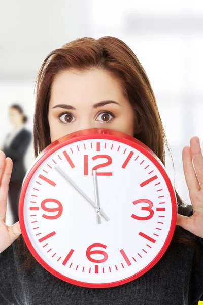 Young woman with clock