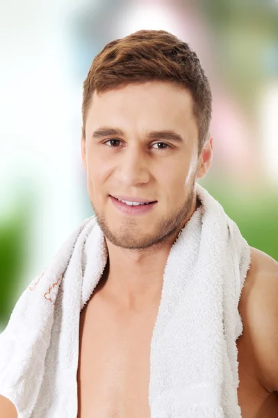 Young athletic man with a towel.