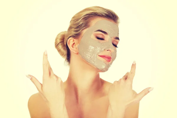 Young happy woman with facial mask.