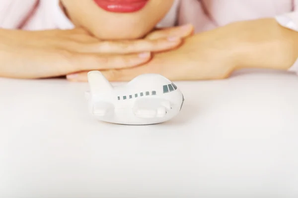 Closeup photo of business woman lying on the desk with toy plane