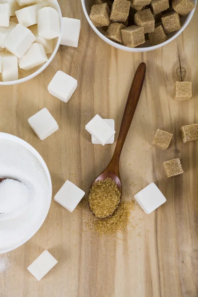 Cane and white sugar in a white bowls