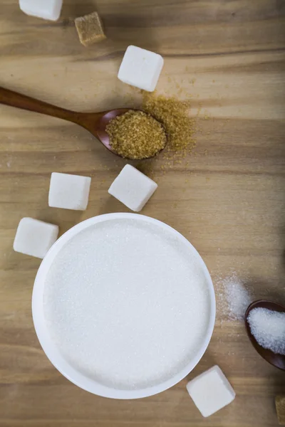 Cane and white sugar in a white bowls