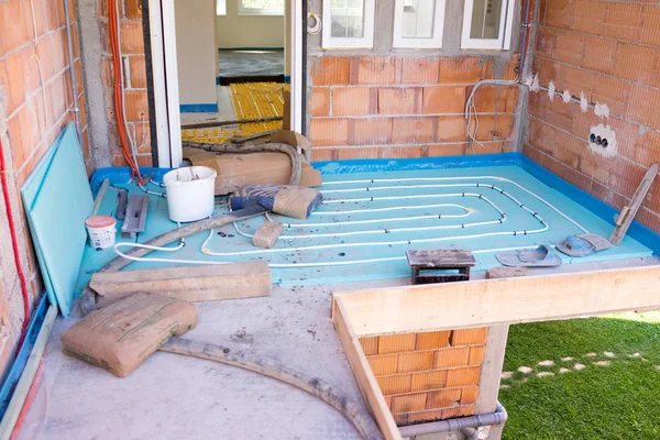 Installing underfloor heating and colling pipes