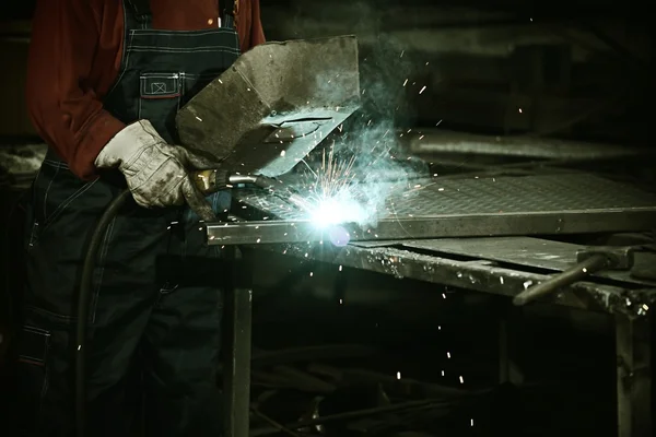 Worker cutting iron with professional tool