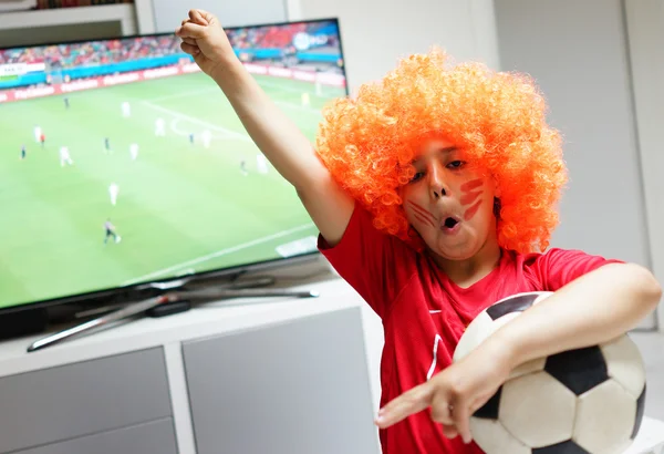 Kid  watching football world cup game on tv