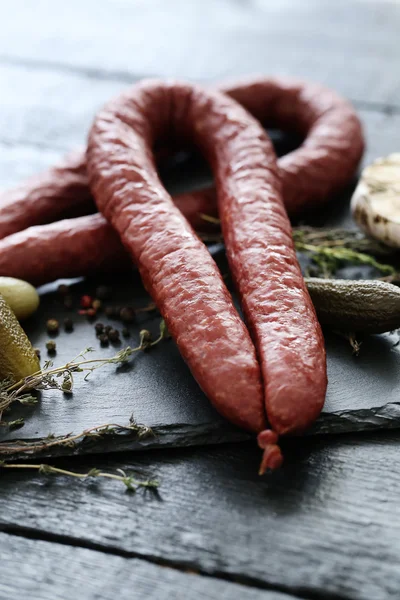 Delicious sausages on table