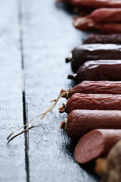 Delicious sausages on table