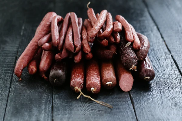 Delicious sausages on table