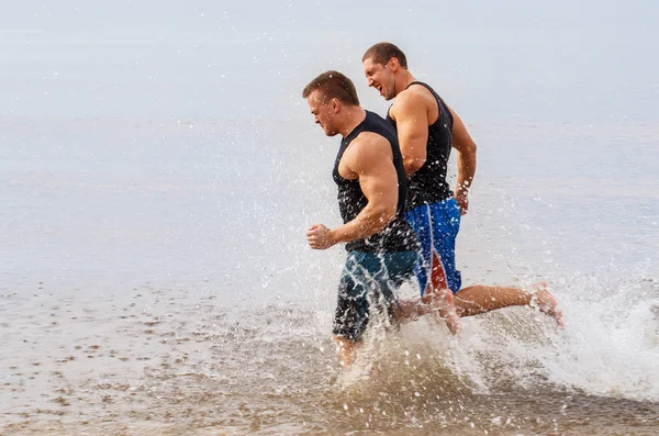 Guys running on the beach