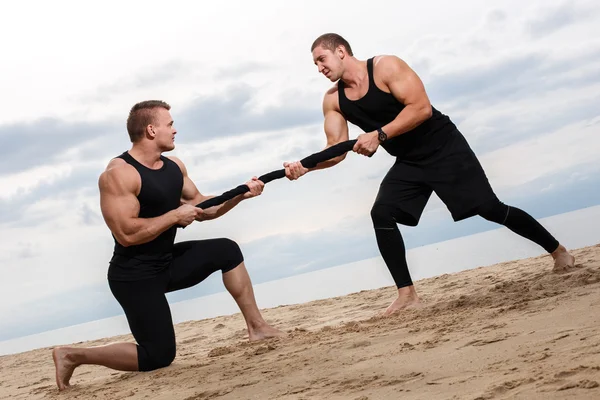 Bodybuilders during workout on the beach