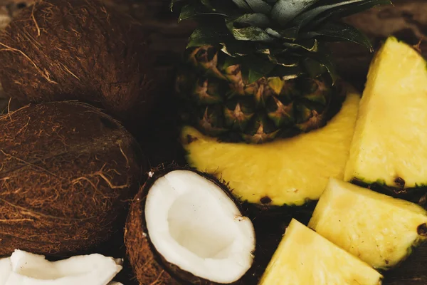 Pineapple with coconut on a wooden table