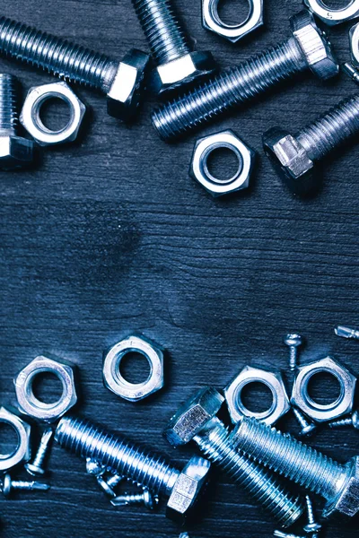 Bolts and nuts on the wooden table