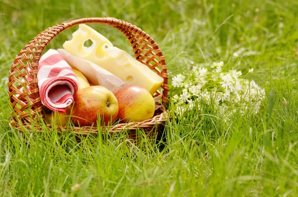 Picnic basket with apples and cheese