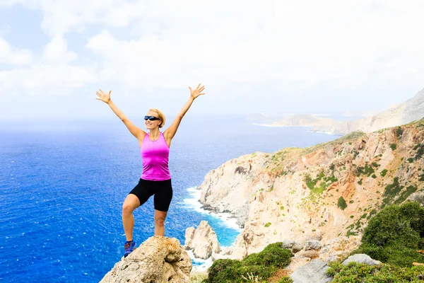 Happy climber woman winner reaching life goal success