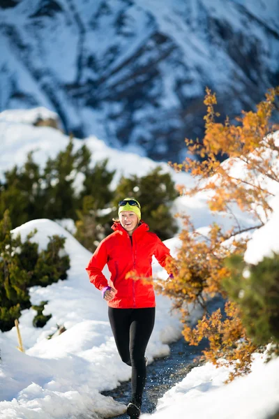 Woman running in winter mountains