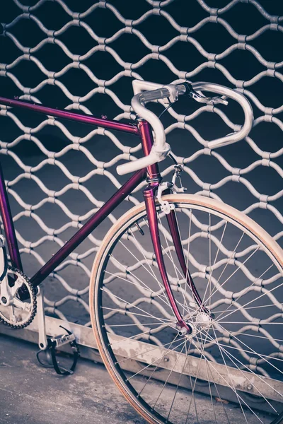 Road bicycle and concrete wall, urban scene vintage style