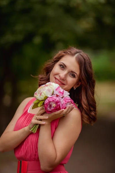 Beautiful woman with buoket of flowers bouquet