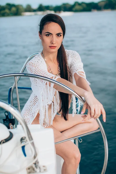 Woman in stylish swimsuit on yacht