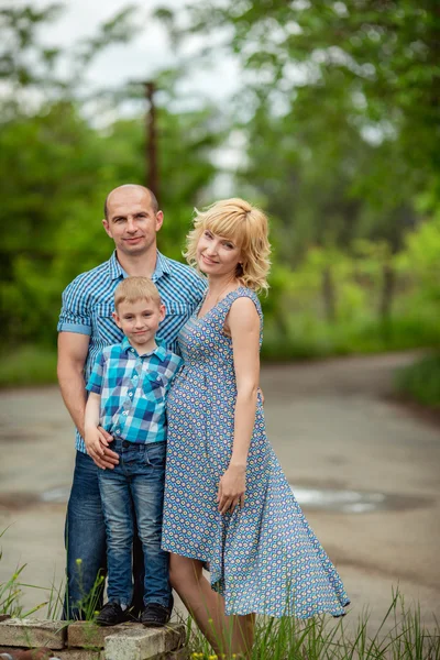 Pregnant woman with her husband and son