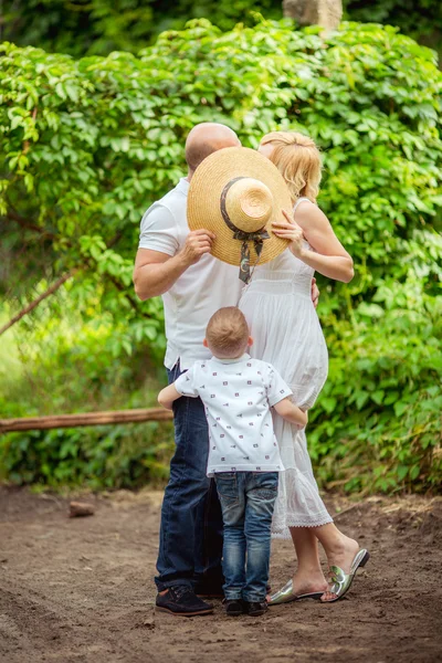 Pregnant woman with her husband and son