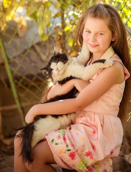 Little girl playing with cat