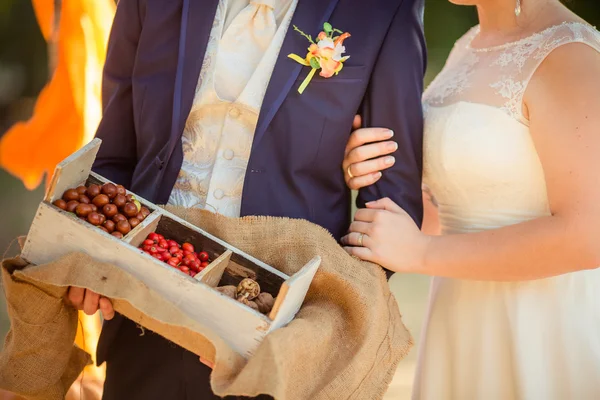 Bride and groom with berries and nuts