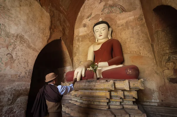 Burmese man brings religious offerings to Buddha