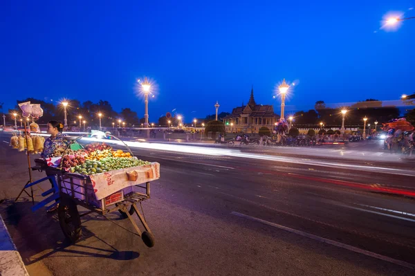 Vendor selling food at evening asian city.