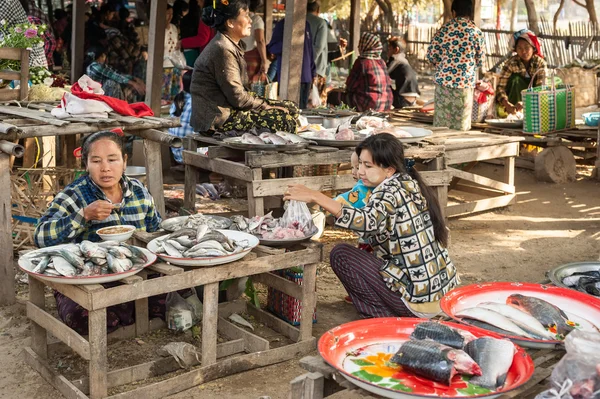 Woman selling fish at asian market