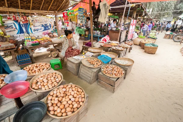 People selling eggs at asian market.