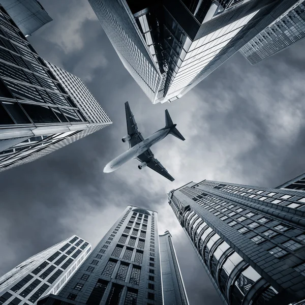 Abstract futuristic cityscape view with airplane flying