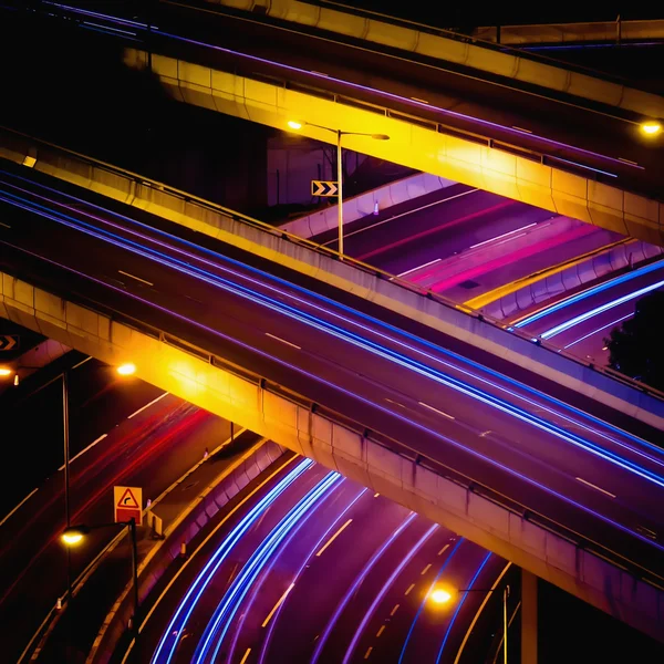 Abstract night view of highway interchange with moving cars. Hong Kong